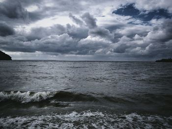 Scenic view of sea against cloudy sky