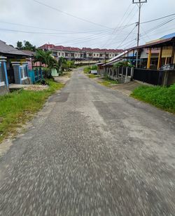 Surface level of road by buildings against sky