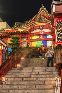 People in illuminated building at night