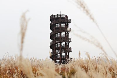 Low angle view of tower on field against sky