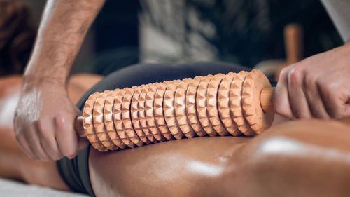 Midsection of man giving massage to woman