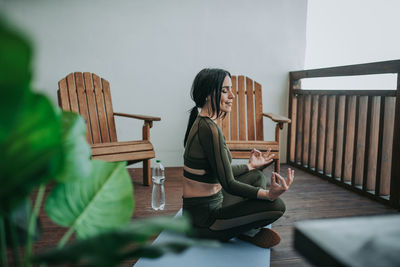 Woman sitting on table at home