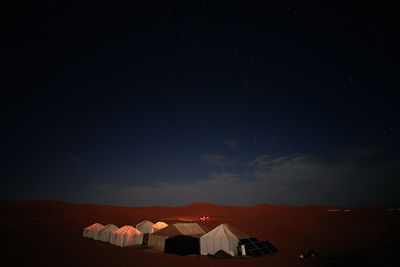 Scenic view of illuminated building against sky at night