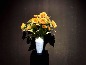 Close-up of flower vase against wall