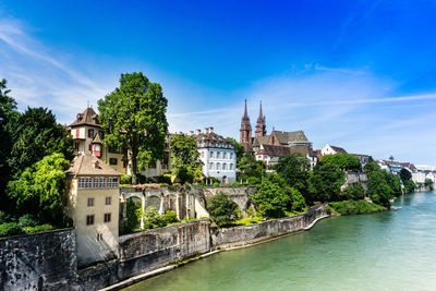 River by church in city against sky