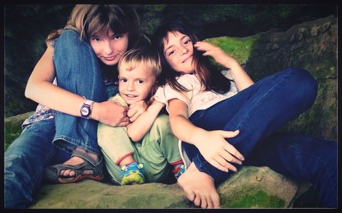 Portrait of friends sitting on floor