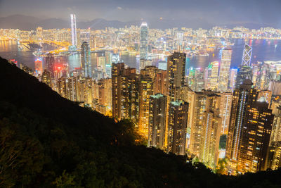 High angle view of illuminated buildings against sky at night