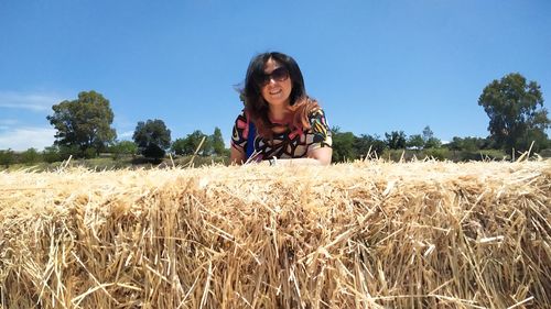 Portrait of young woman standing in farm