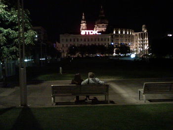 People sitting in city at night