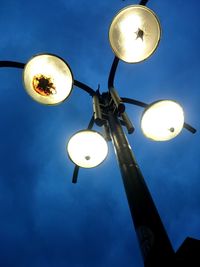 Low angle view of lamp post against sky