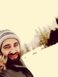 Portrait of a smiling man in snow