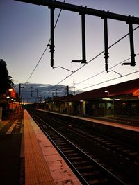 Train at railroad station against sky