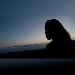 Side view of silhouette woman against sky during sunset