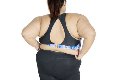 Midsection of woman standing against white background