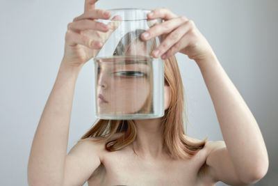 Midsection of woman drinking glass