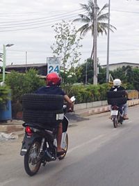 Side view of man riding bicycle on road