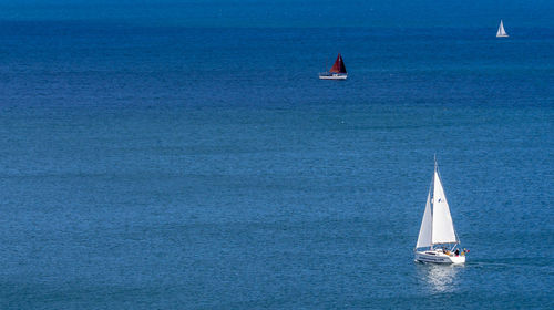 Sailboat sailing on sea against sky