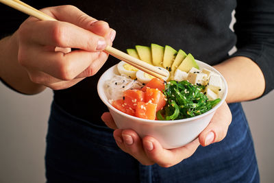 Midsection of woman holding food