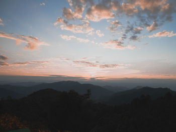 Scenic view of silhouette mountains against sky at sunset