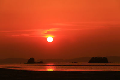 Scenic view of sea against romantic sky at sunset