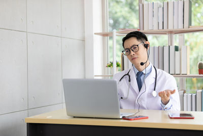 Doctor talking on video call at hospital