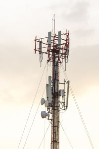 Low angle view of communications tower against sky during sunset