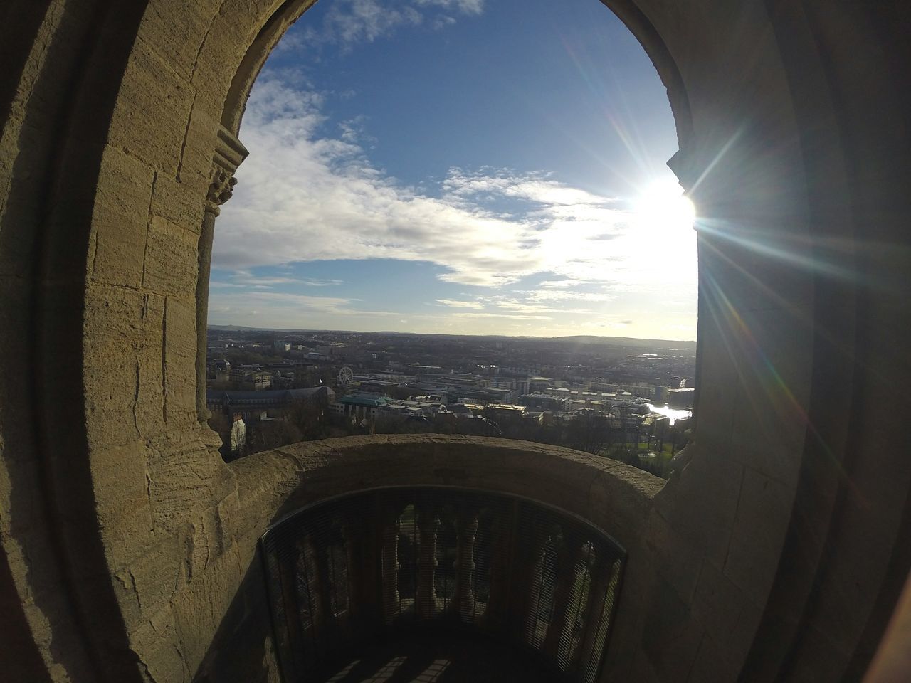 CLOSE-UP OF CITYSCAPE AGAINST SKY SEEN THROUGH ARCHWAY