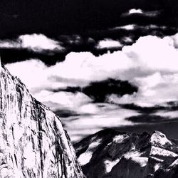 Scenic view of mountains against cloudy sky