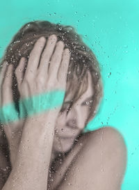 Close-up portrait of wet woman in rain