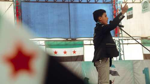 Boy giving speech on stage