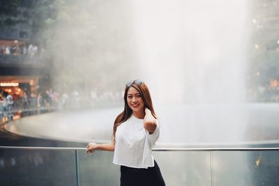 Portrait of a smiling young woman standing outdoors