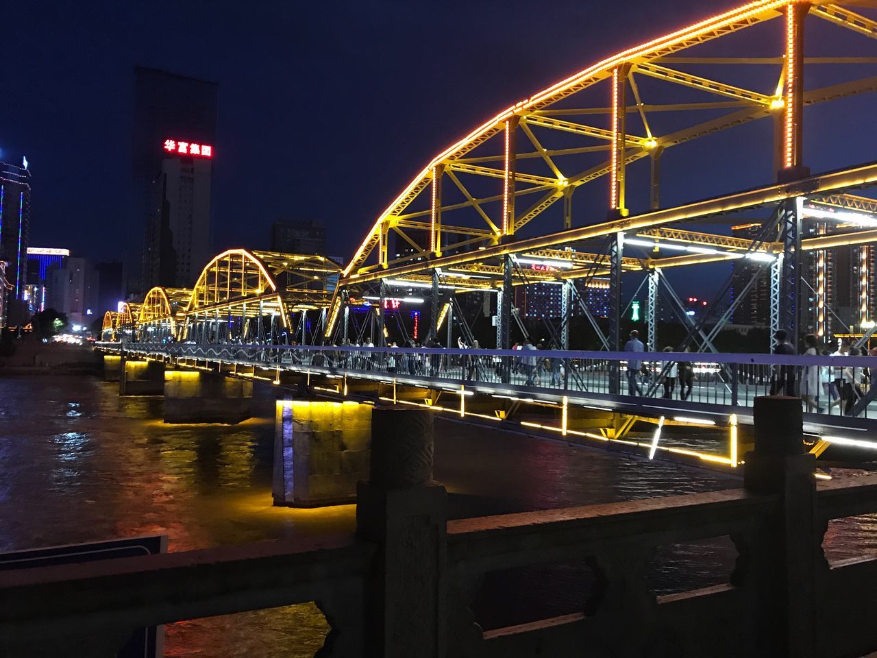 ILLUMINATED BRIDGE OVER RIVER