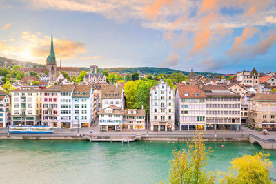 Buildings in city against cloudy sky