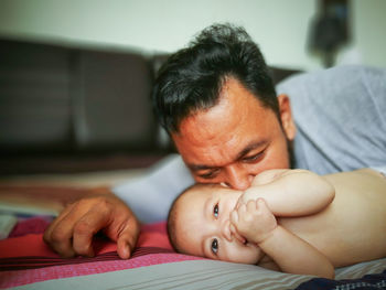 Portrait of cute baby on bed at home