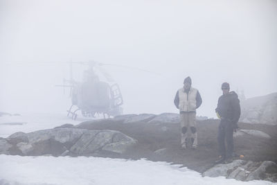 Helicopter pilot and passenger wait out bad weather, poor visibility.