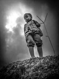Low angle view of boy against sky