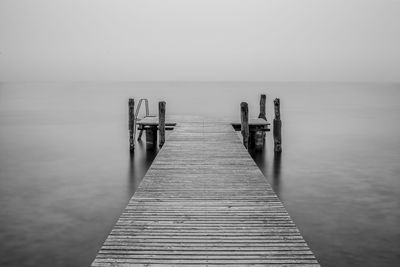 Pier over sea against sky