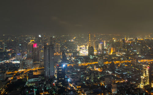 High angle view of illuminated city buildings at night
