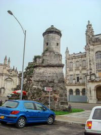 Cars parked on road against buildings