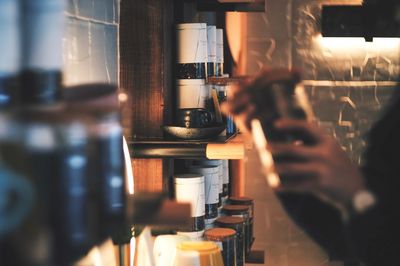 Cropped image of person holding jar