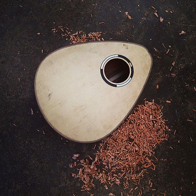 high angle view, still life, directly above, circle, close-up, coffee cup, no people, heart shape, single object, overhead view, outdoors, day, street, shadow, drink, textured, abandoned, table, geometric shape, elevated view