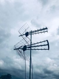 Low angle view of telephone pole against sky