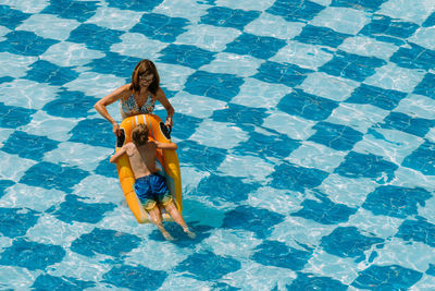 High angle view of woman standing in swimming pool