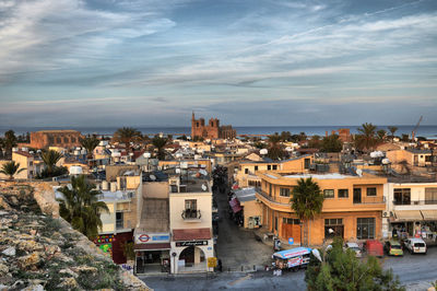 High angle view of buildings against cloudy sky during sunset