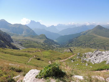 Scenic view of valley and mountains against sky