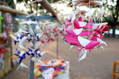 Close-up of multi colored bird and fish hanging for sale