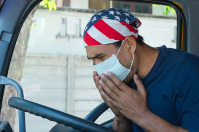 Midsection of man sitting in car