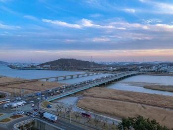 High angle view of bridge over river against sky in city