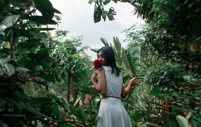 Woman standing against plants