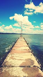 View of jetty in sea against sky